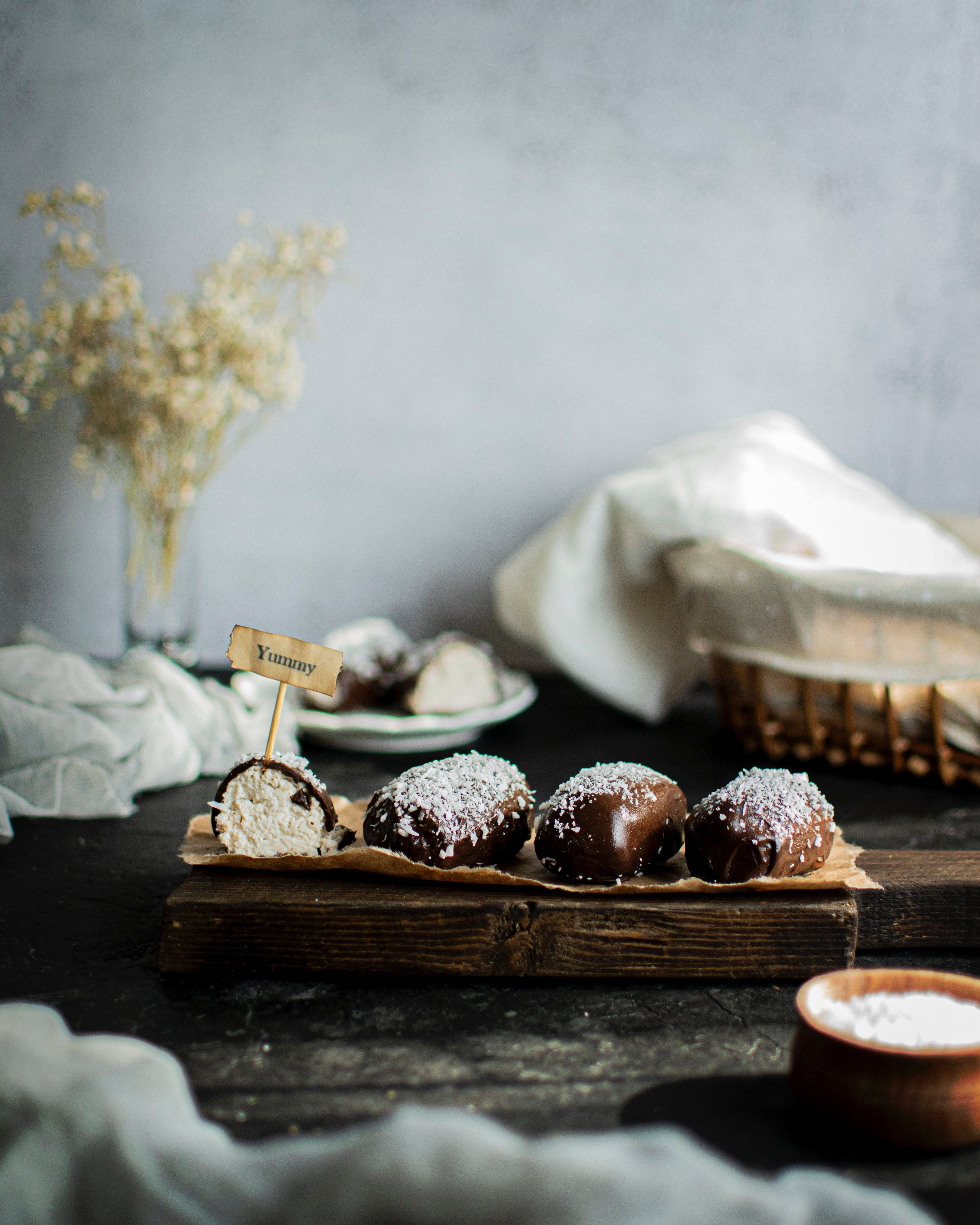Enticing chocolate-covered pastries on a rustic tray, perfect for dessert lovers.