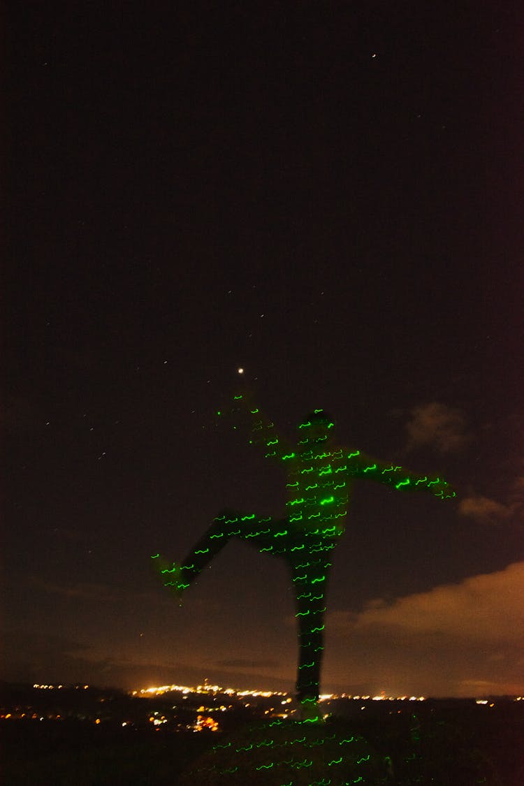 Man In Green Lights On Night City Background