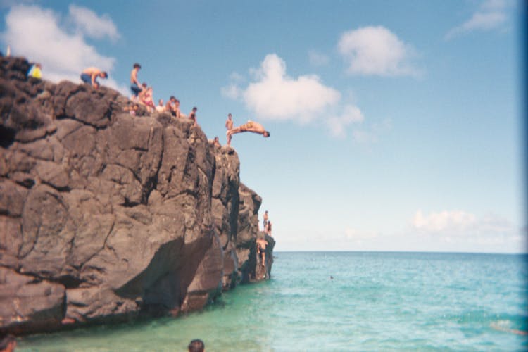 People Looking At The Man Diving On The Sea