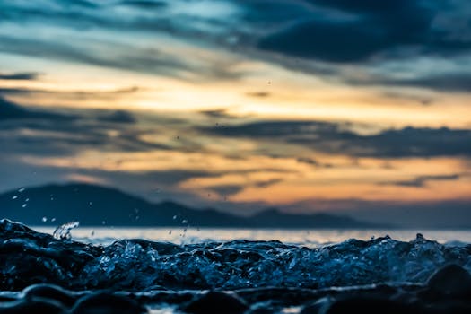 Captivating sunset view with ocean waves and a dramatic sky backdrop.