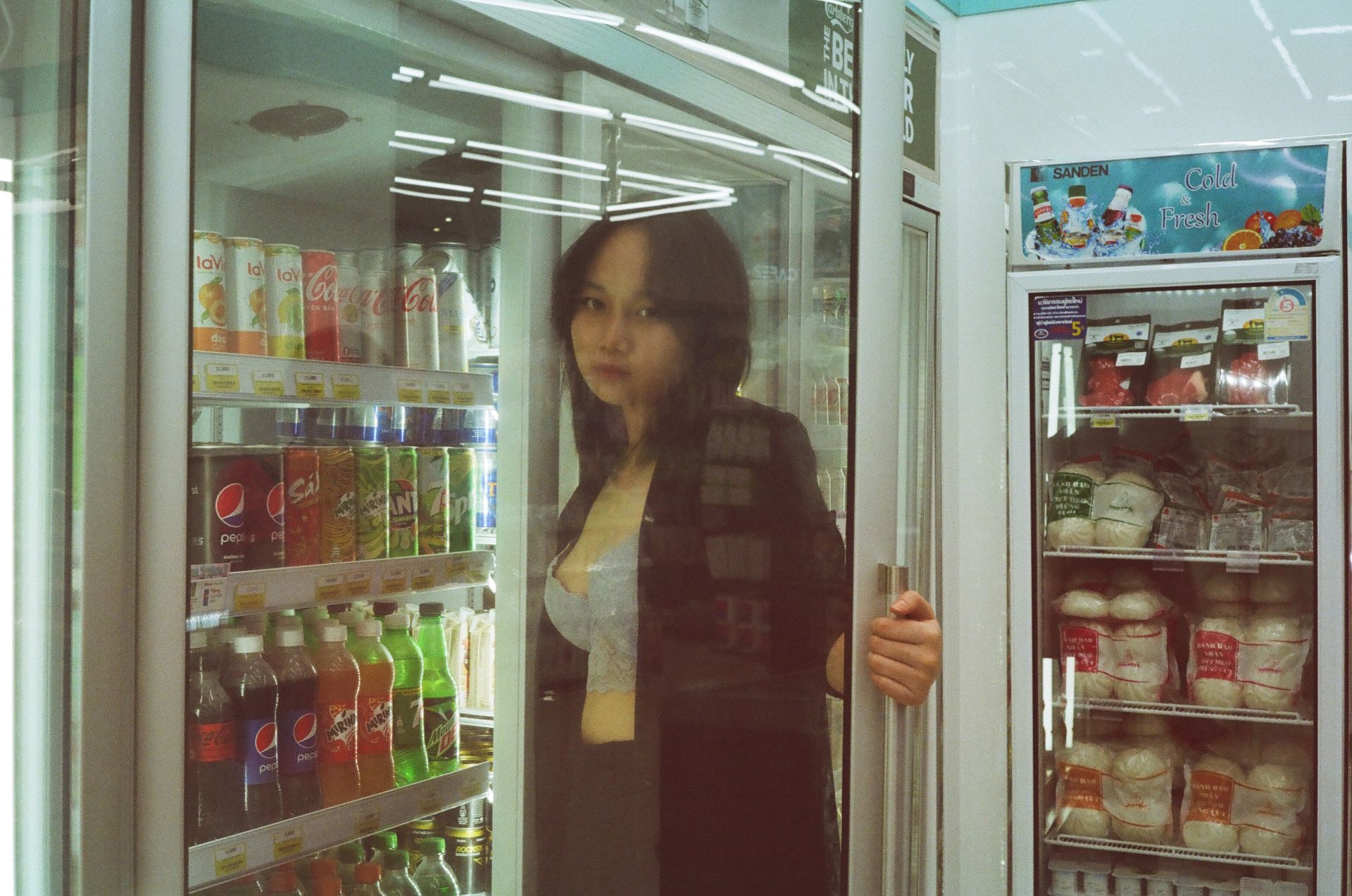 A Woman Holding a Refrigerator Door