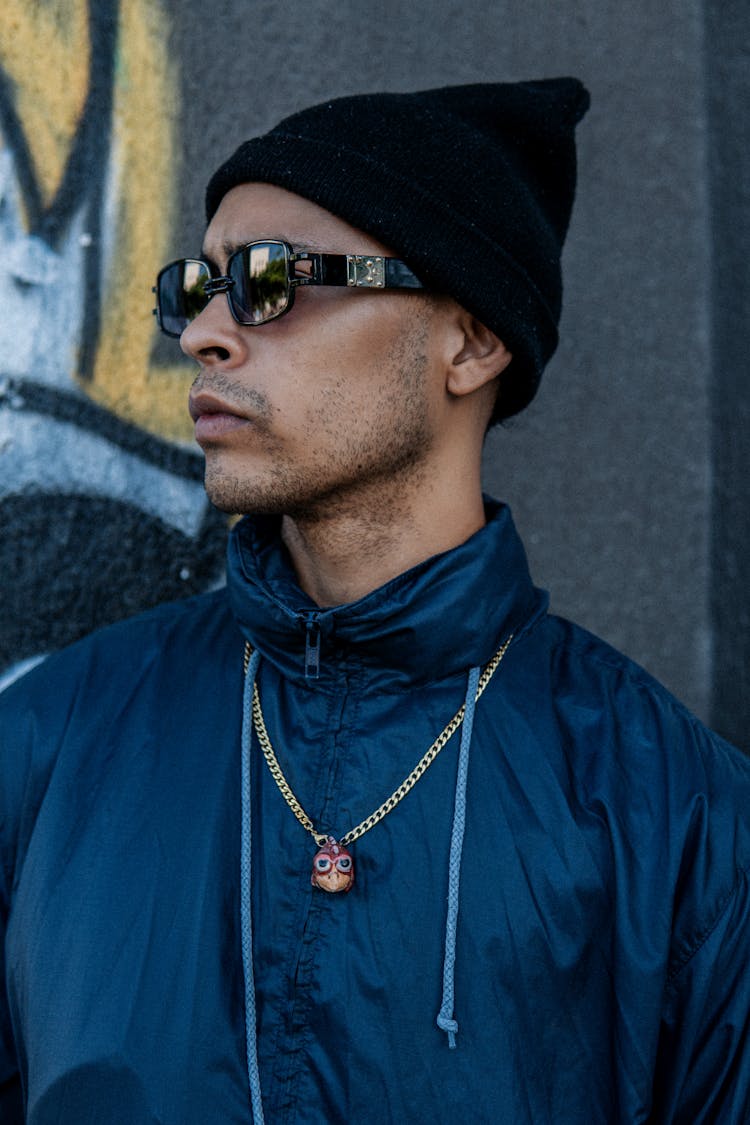 Portrait Of Man In Sunglasses And Black Cap