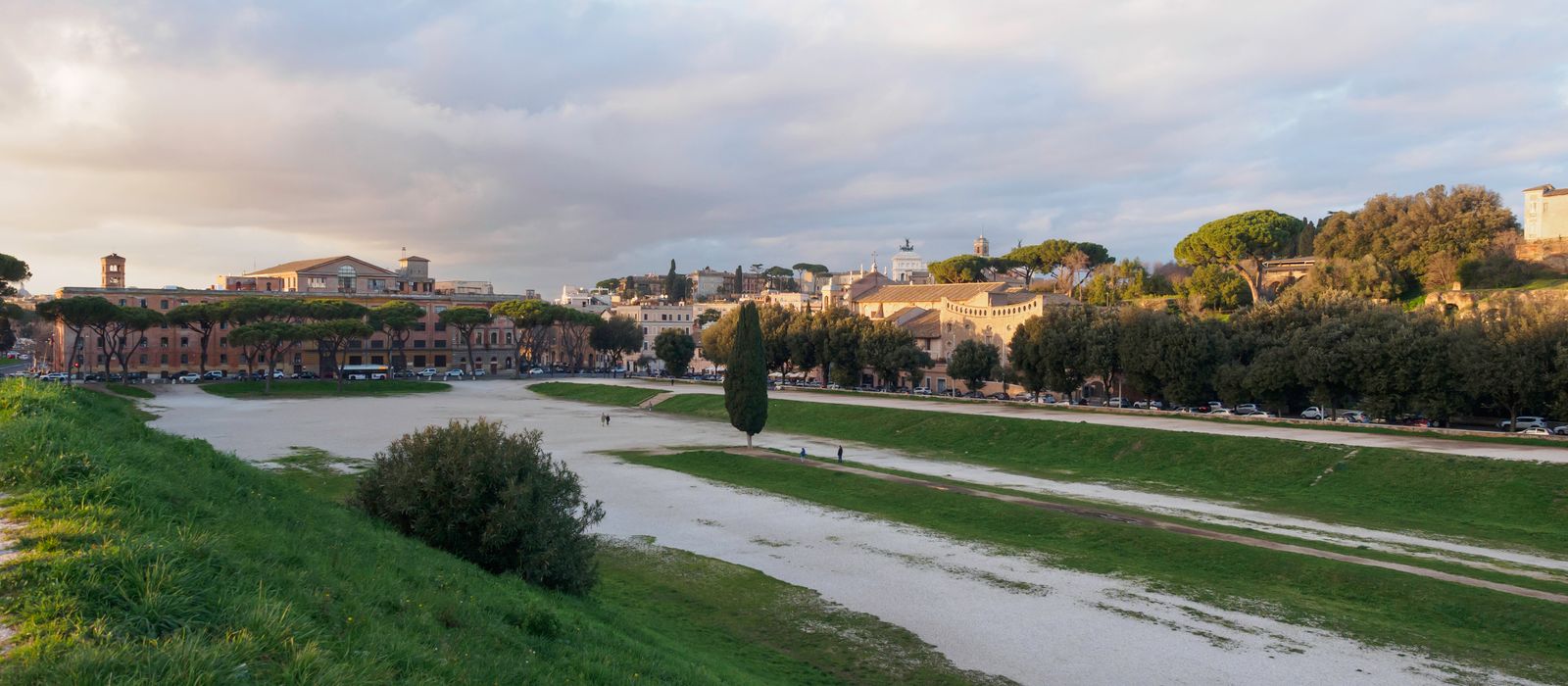 Beautiful landscape of Circus Maximus in Rome with lush greenery and a historic backdrop.