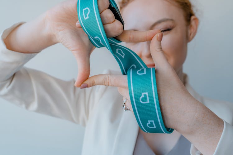 Woman Holding A Lanyard And Doing Hand Sign