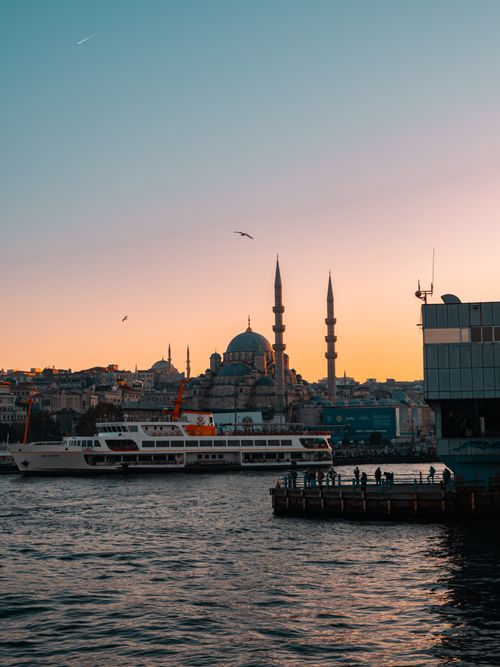 Free Stunning sunset over Istanbul with a mosque and boats in the Bosphorus. Stock Photo
