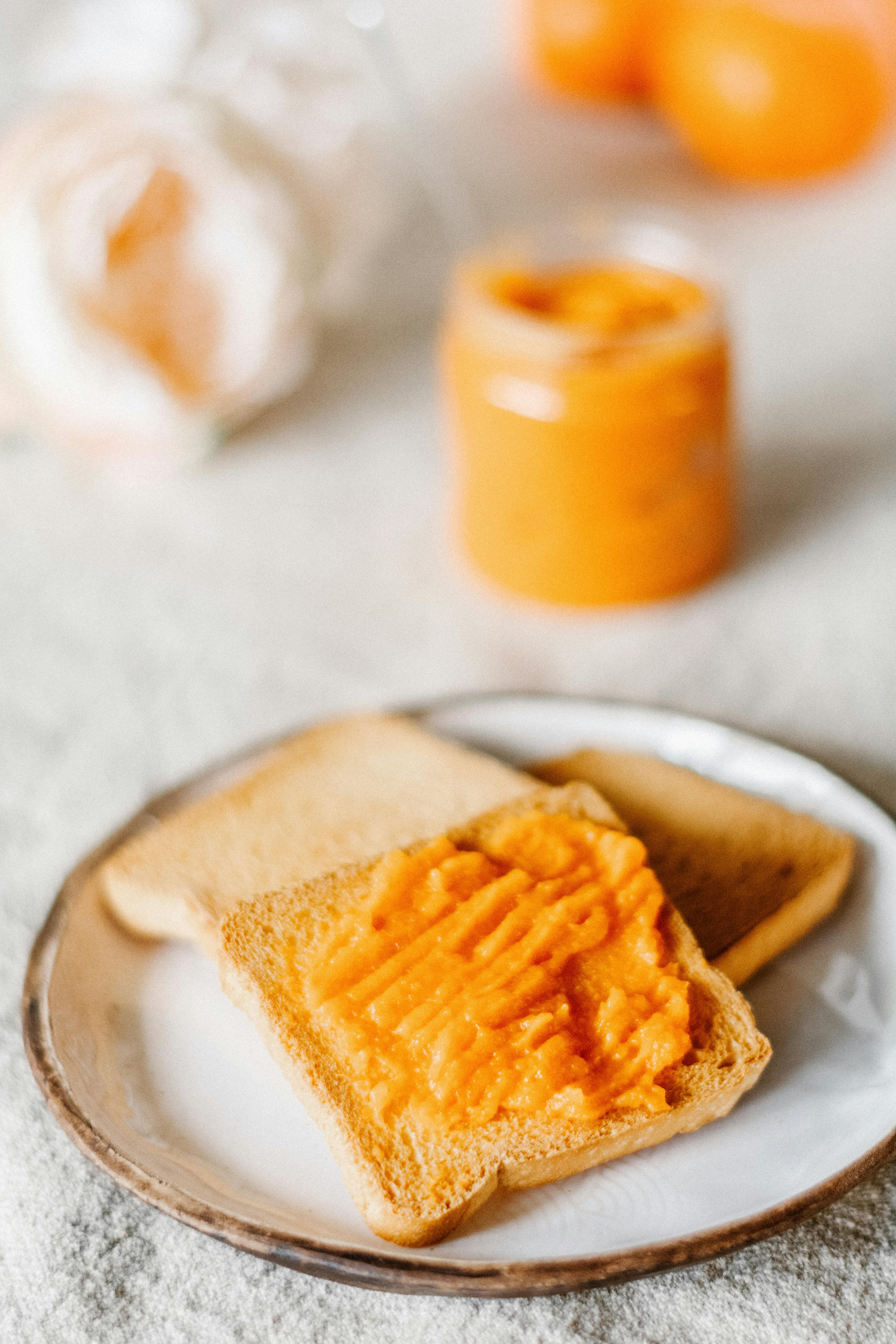 photo of an orange jam on a piece of bread