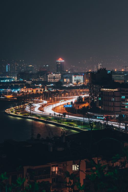 Free Long exposure night view of İzmir cityscape with light streaks and skyline reflections. Stock Photo