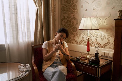 Free Sitting Woman Smoking in Bedroom Stock Photo