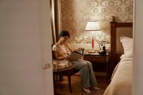 Free Sitting Woman Watching Old Photos in Album Stock Photo