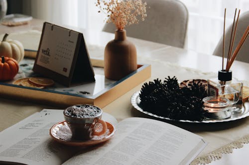 A Cup of Coffee in Saucer Over a Book