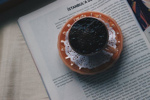 Free A Black Coffee over a Book Stock Photo