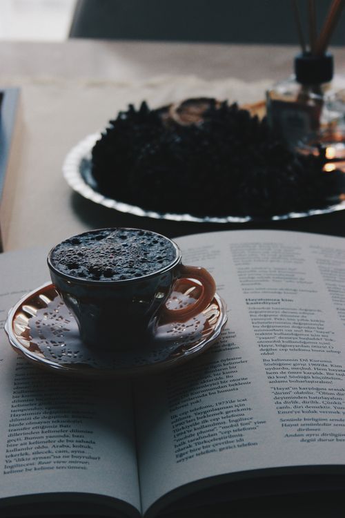 Free Cup of espresso placed on an open book, creating a cozy reading atmosphere. Stock Photo