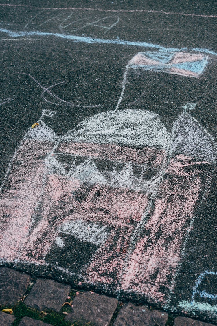 A Chalk Drawing Of A Castle On Concrete Surface