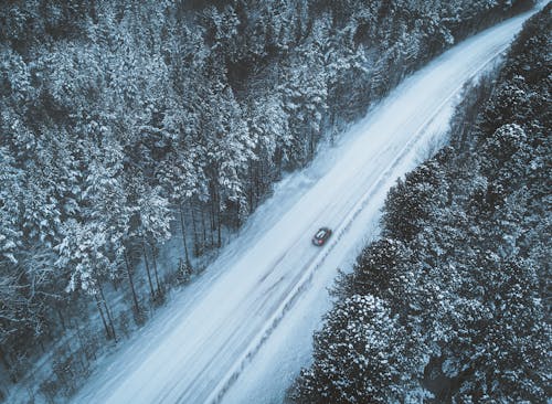 Car Driving on a Snow Covered Road