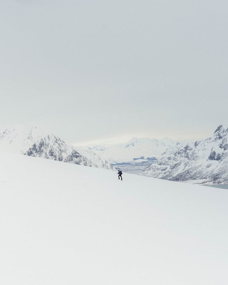 Distant Mountain Climber In Winter