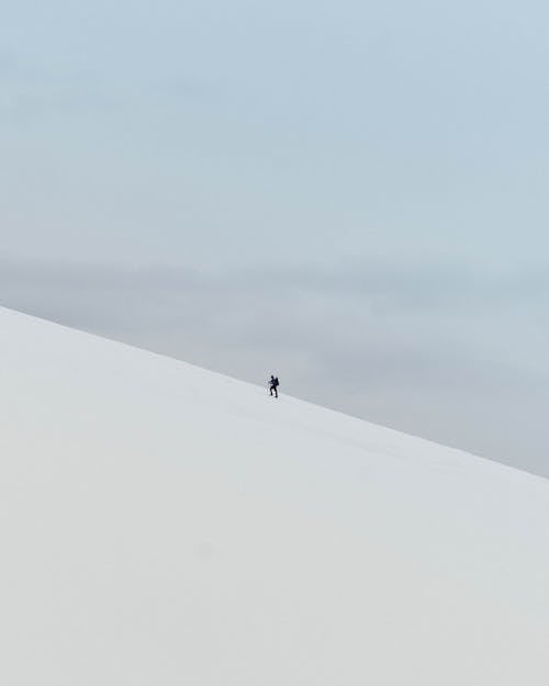 Man Climbing Mountain in Winter