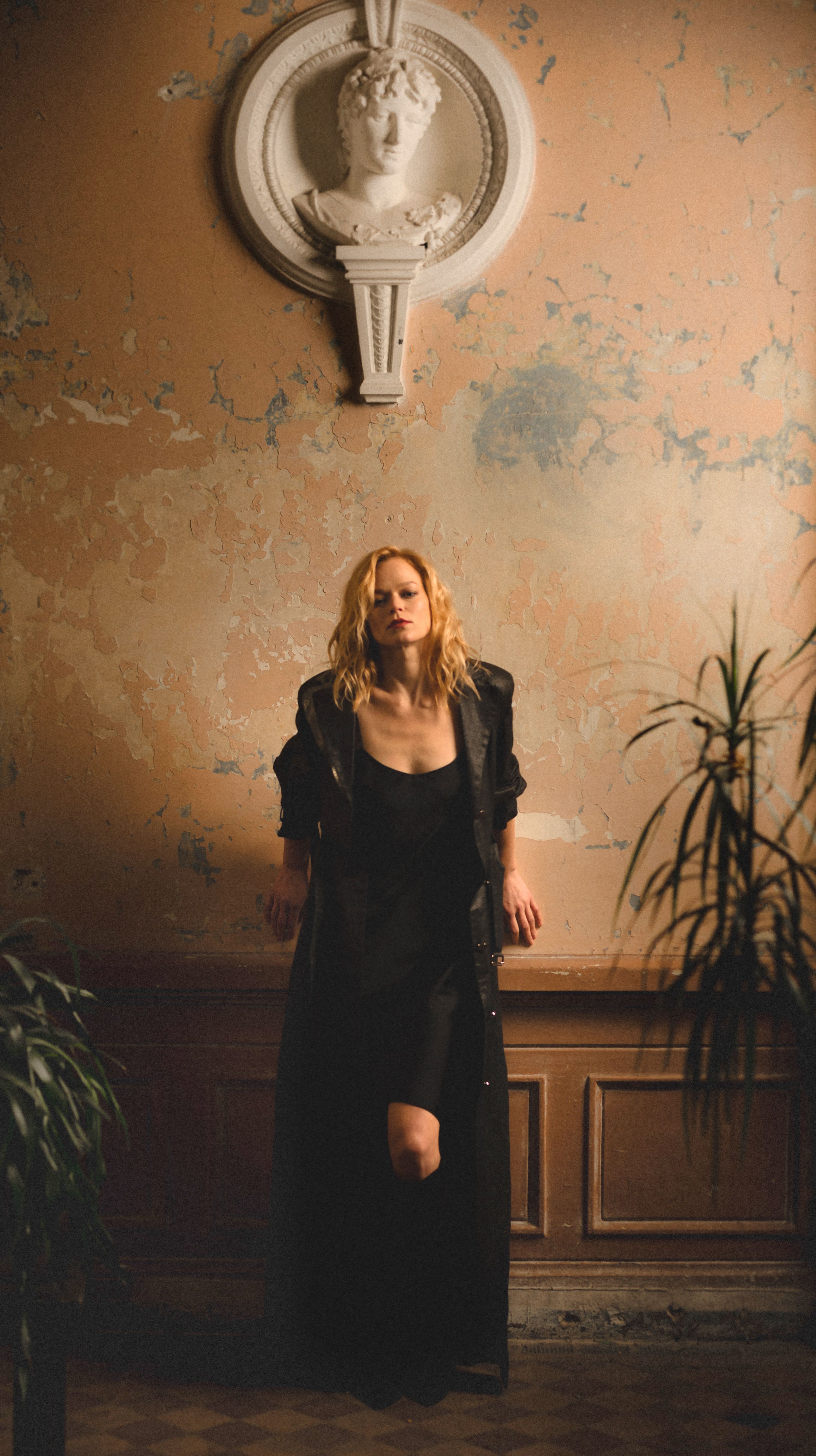Woman in Black Dress Leaning on the Wall · Free Stock Photo