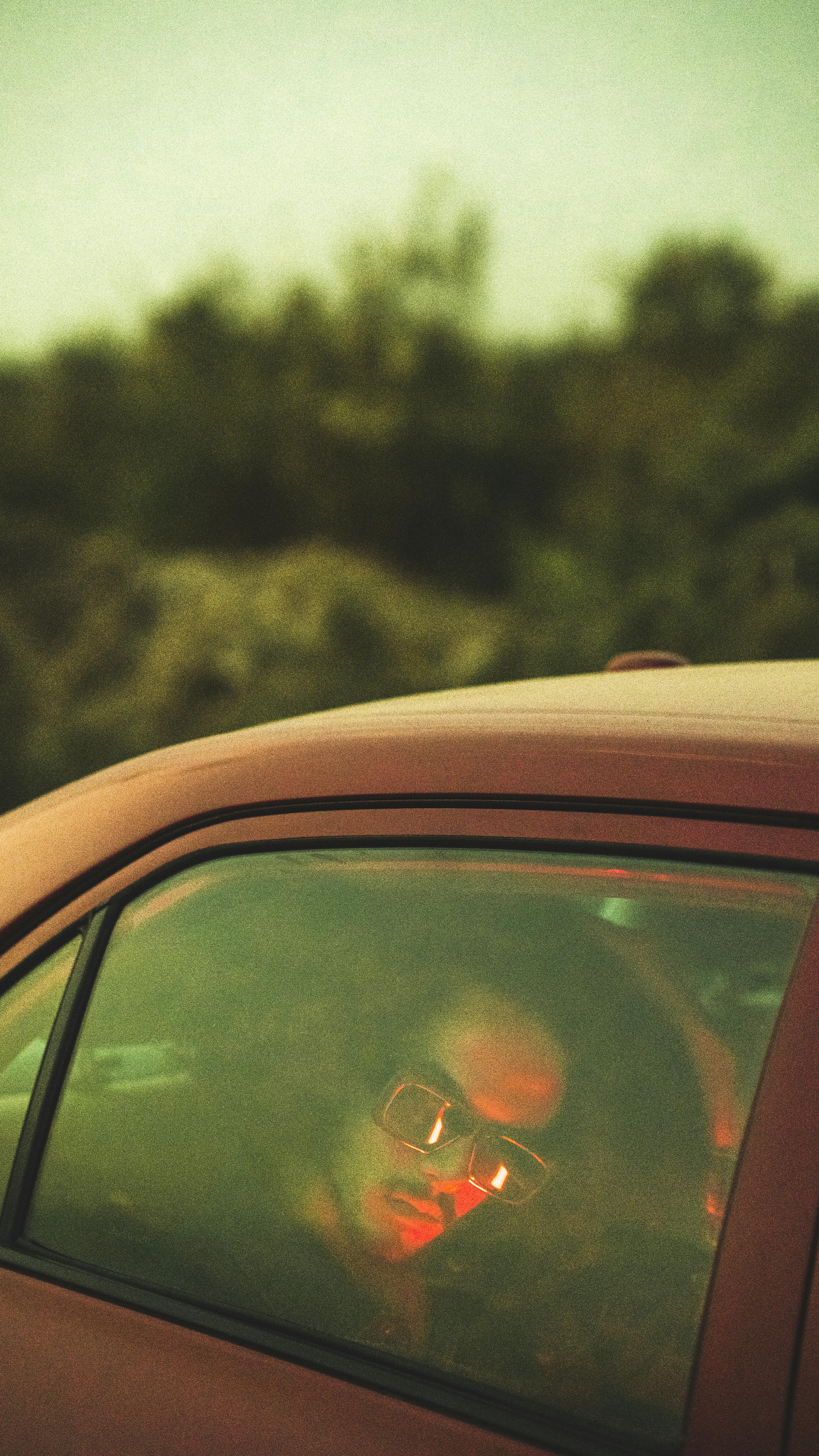 man in car seen through window