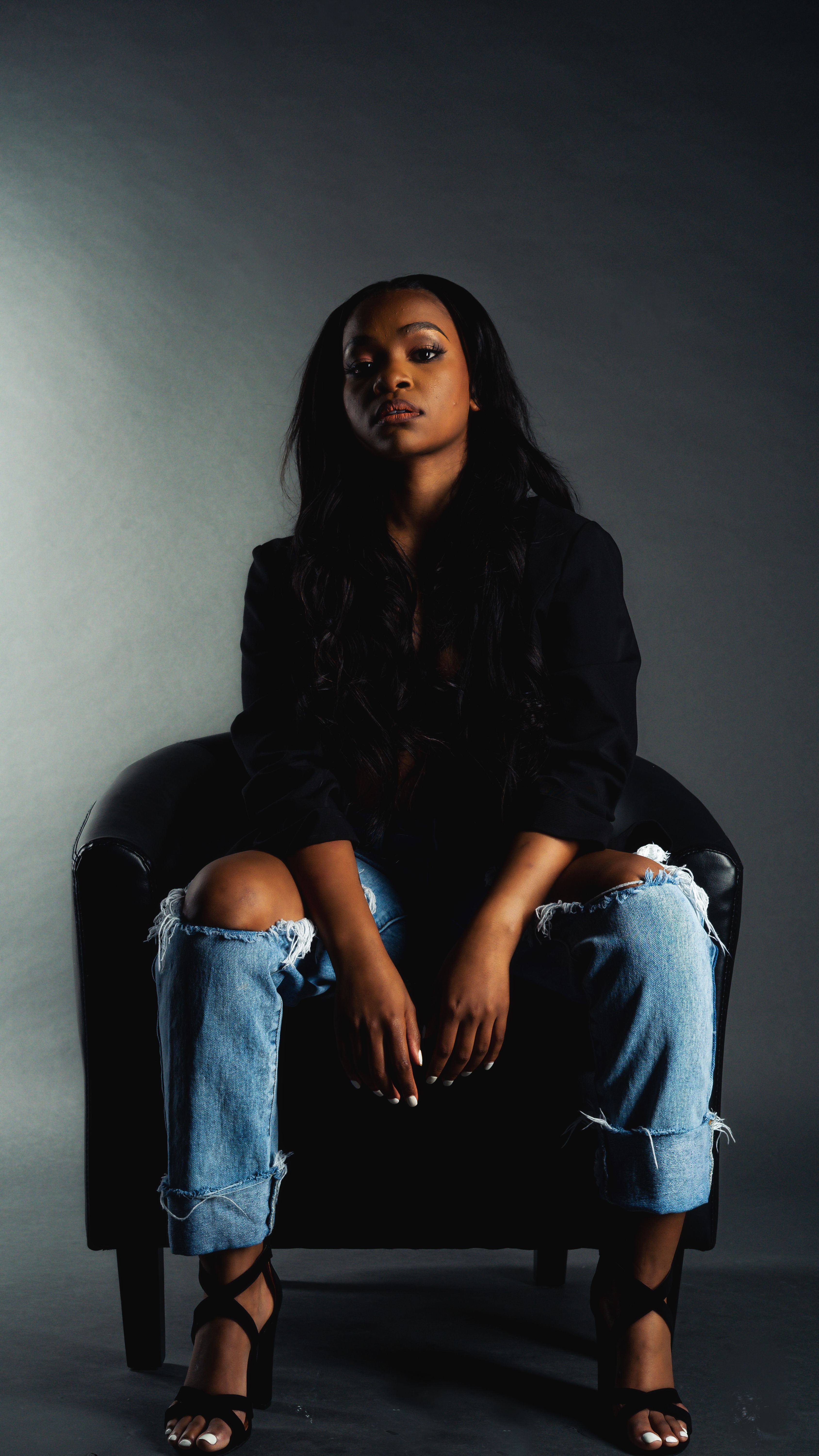 A Woman in Black Long Sleeve Sitting on the Chair · Free Stock Photo