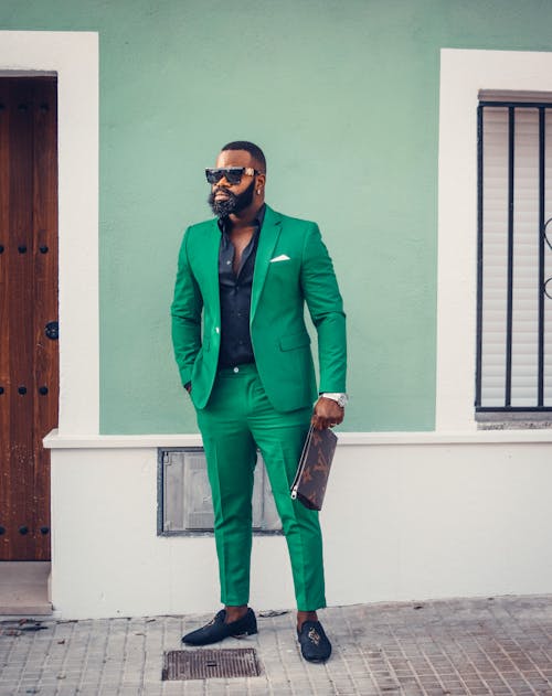 Photo of a Man with Sunglasses Wearing a Green Suit