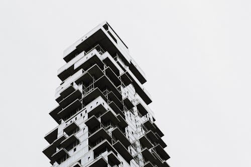 Grayscale Photo of High Rise Concrete Building