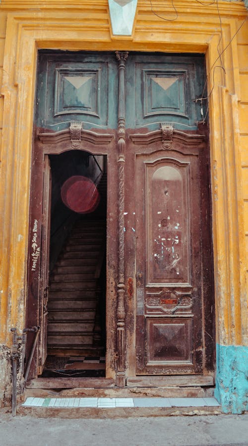 Brown Wooden Door With Yellow Concrete Frame