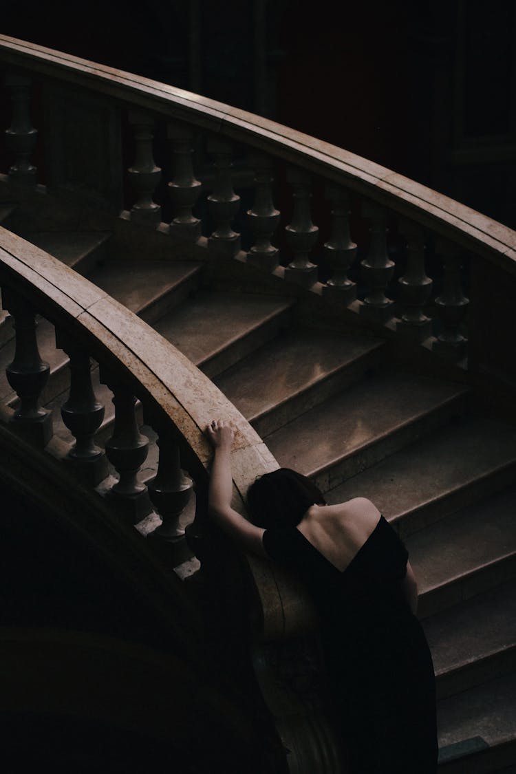 Woman In Black Dress On Staircase