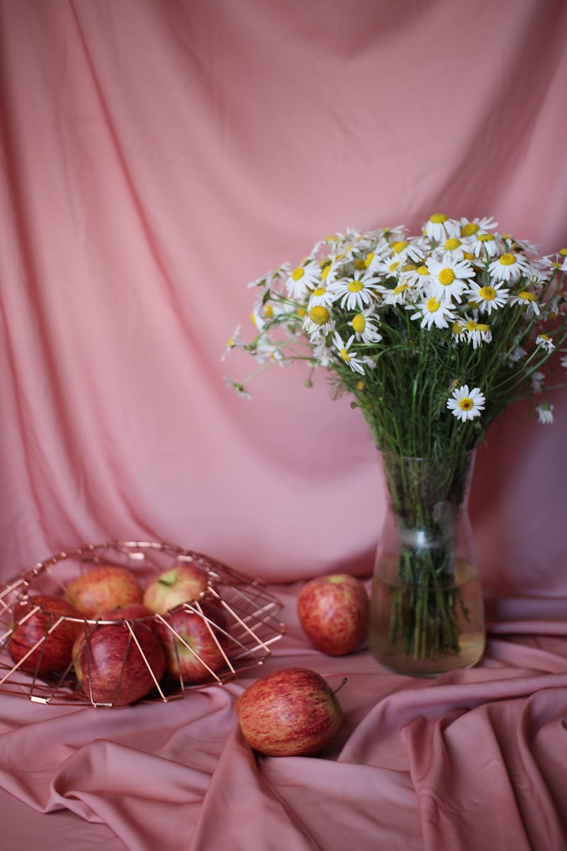Ruddy Apples in Metal Basket and Bunch of Marigolds