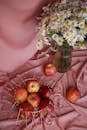 Picture of Marigolds in Glass Vase and Red Apples