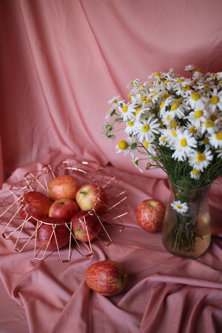 White Flowers And Red Apples On Pink Background