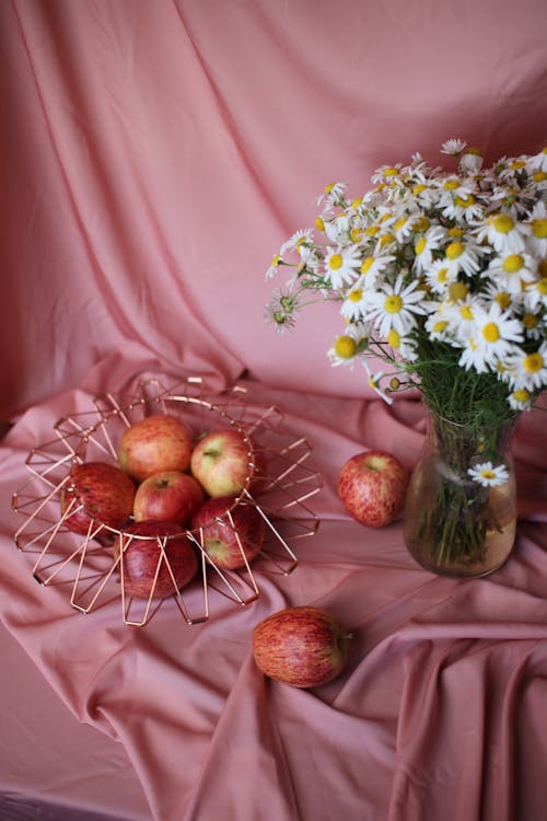 A Daisy Flowers and Apples on the Table
