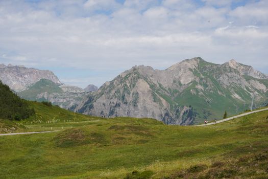 Explore the breathtaking alpine landscape of Silbertal, Austria, with lush green fields and majestic mountains.