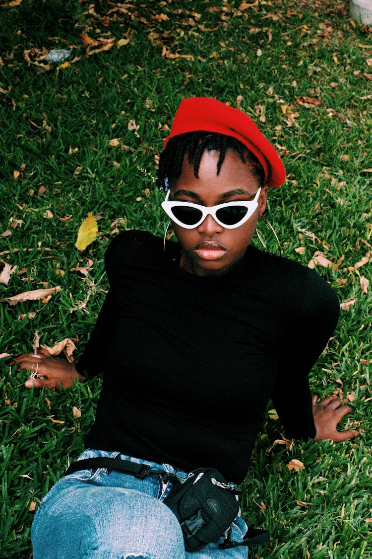 Portrait Of Woman Laying On Grass