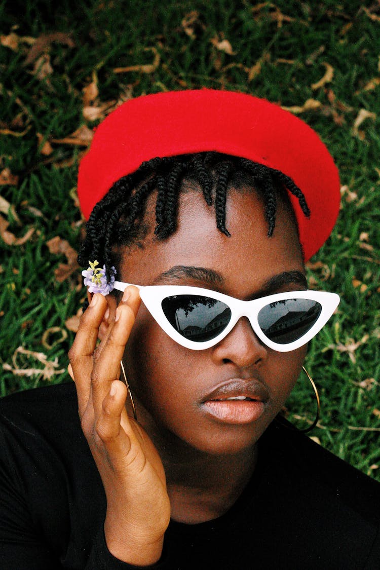 Portrait Of Woman In White Rimmed Sunglasses And Red Beret