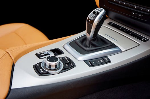 Close-up of a luxury car's interior with a focus on the modern gear shift and control panel.
