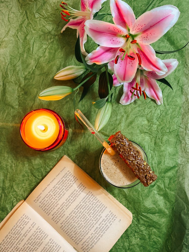 Overhead Shot Of A Candle Near Madonna Lily Flowers