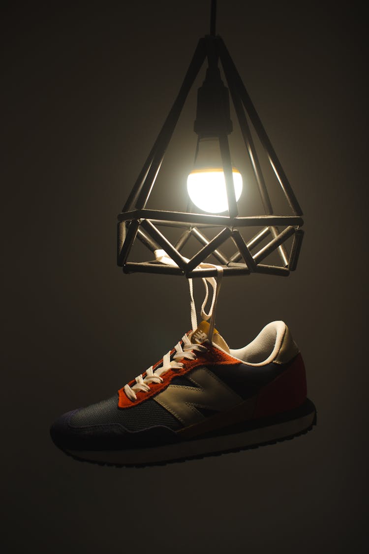 Photo Of A Shoe Hanging From A Light