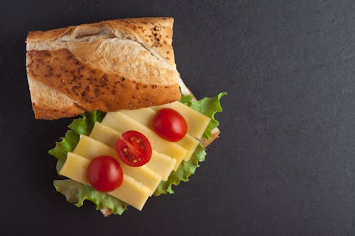Free Overhead Shot of Slices of Cheese and Tomatoes in a Sandwich Stock Photo