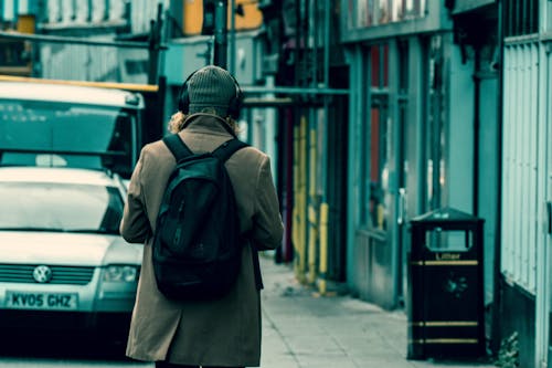 Back View of a person with a Black Backpack Wearing a Gray Beanie