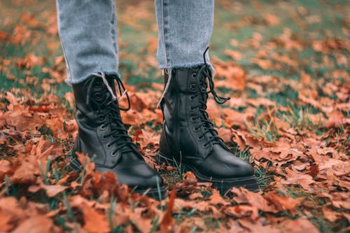 Photo of a Person Wearing Black Leather Boots