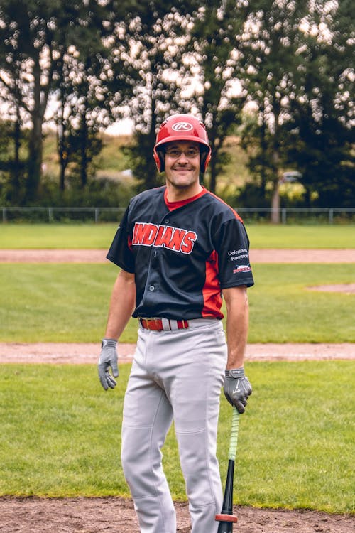 Photo of a Man Wearing a Black and Red Baseball Uniform