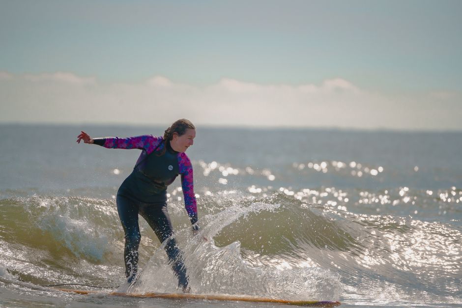 Woman surfing in Cocoa Beach, FL, showcasing ocean adventure and sport action.