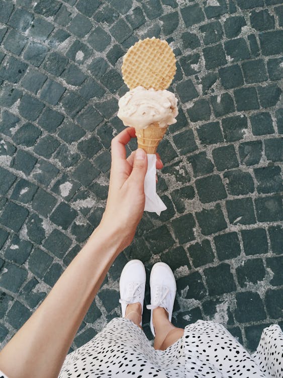 Free Person Holding Ice Cream in Cone Stock Photo