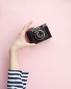 Person Holding Black Point And Shoot Camera