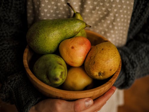 Green and Yellow Fruits in Brown Wooden Bowl