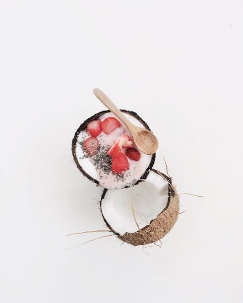 Free Wooden Spoon on an Opened Coconut  Stock Photo