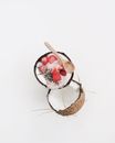 Wooden Spoon on an Opened Coconut