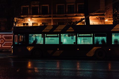 Silhouette of a city bus on wet night streets — photo by Roman Ska on Pexels