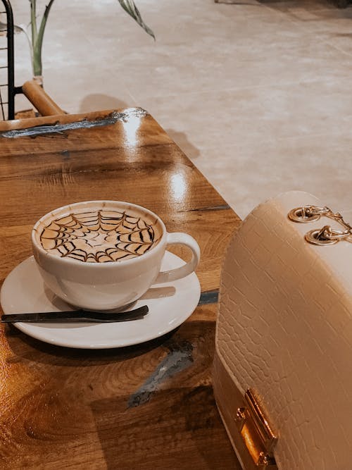 Free A Cup of Coffee on a Wooden Table Stock Photo