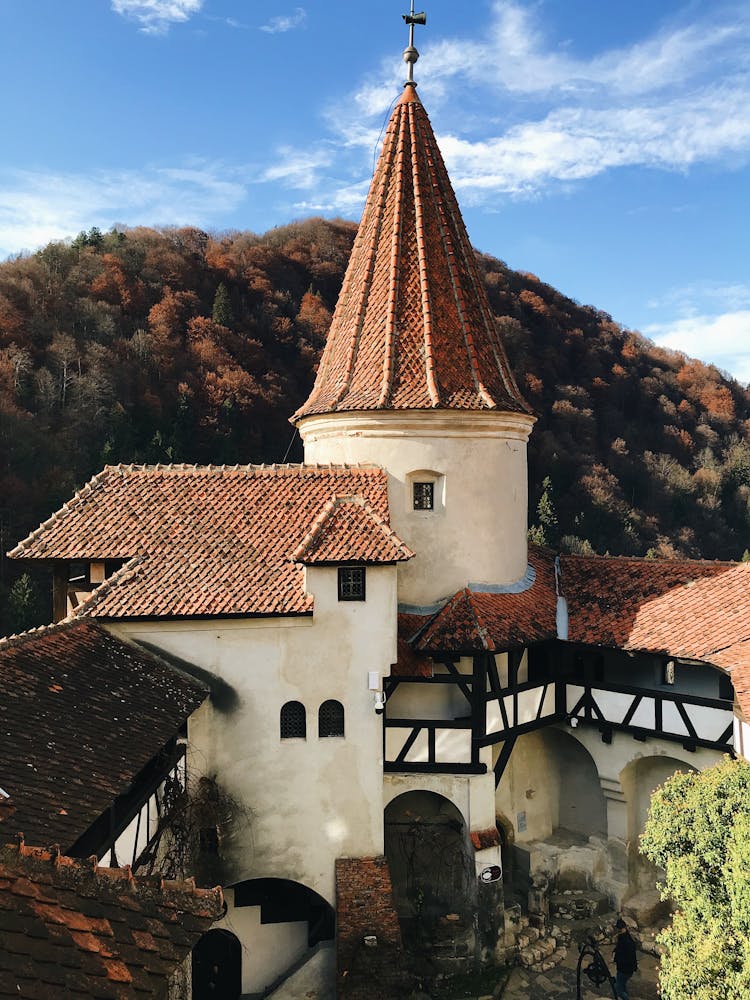 Part Of The Bran Castle On The Background Of A Hill Covered In Autumnal Trees, Bran, Transylvania, Romania 